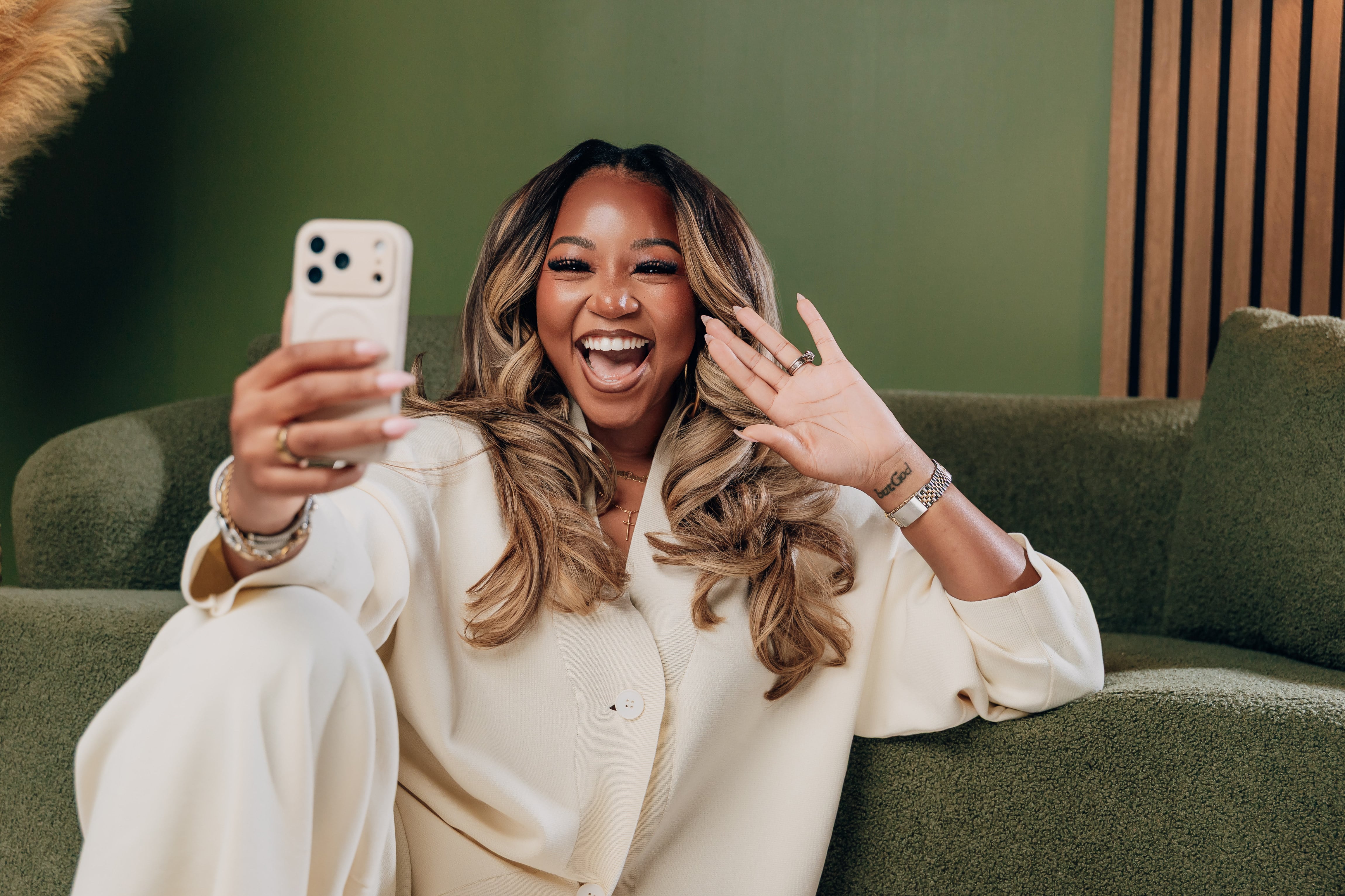 Janesha taking a selfie on the sofa