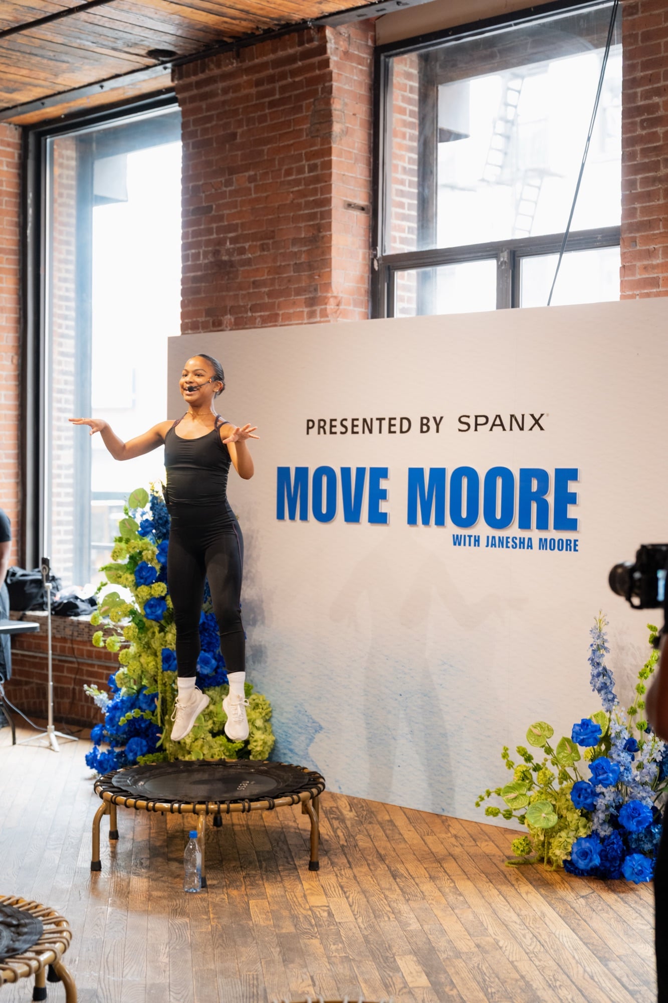 Janesha in front of the Move Moore backdrop